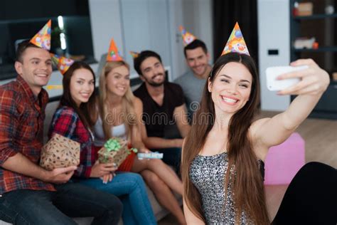 The Birthday Girl Makes A Selfie With Guests On The Couch They Are All Smiling And Posing For A