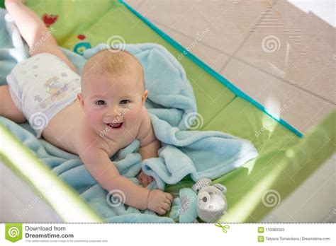 Little Cute Baby Boy Playing With Toys In A Mobile Crib On A Sunny Day