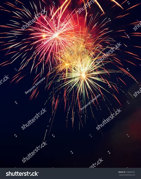 Colorful Fireworks Bursting In The Night Sky Stock Photo 136687541