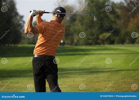 Young Man Swinging Golf Club Rear View Stock Photo Image Of Casual