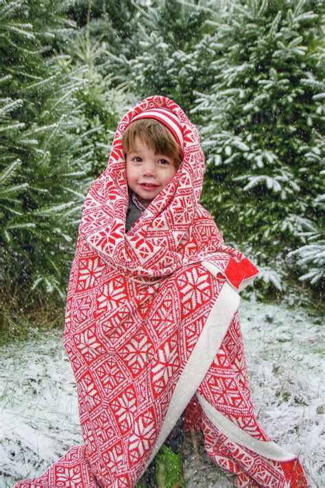 Boy Standing Outside In Snow Wrapped In Blanket Stock