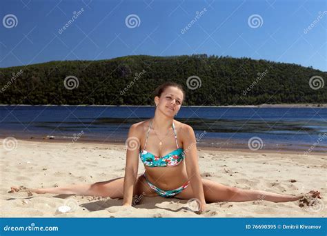 Girl In Bathing Suit Sitting On Splits Sunny Beach Royalty Free Stock Photo Cartoondealer Com