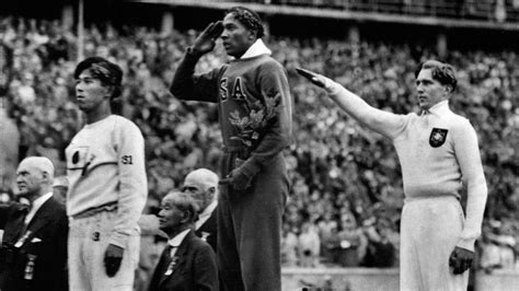 Jesse Owens Salutes The American Flag After Winning A Gold Medal At The