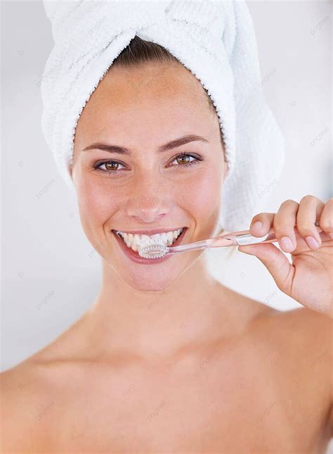 Closeup Of A Beautiful Woman Brushing Her Teeth And Maintaining Dental Hygiene Photo Background