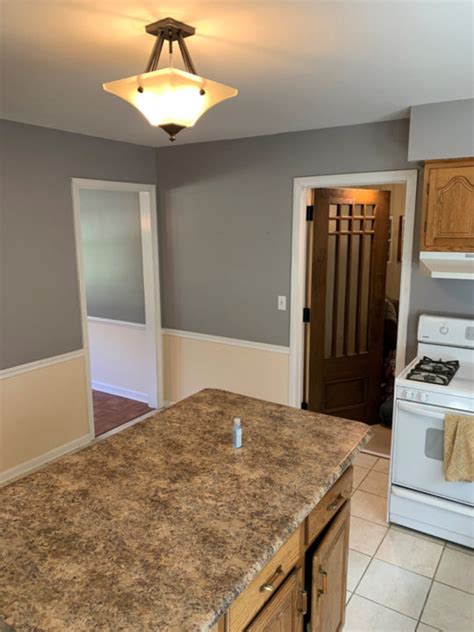 Waiter pours wine for rich middle aged couple, man keeps smiling inanely. 80s Style Kitchen Dining Room Before - Corinthian Fine Homes