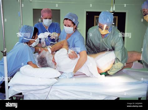 Double Hip Replacement Surgery Surgical Team Turning A Patient During