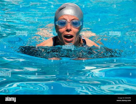 A Woman Swims In An Outdoor Hotel Swimming Pool Stock Photo Alamy