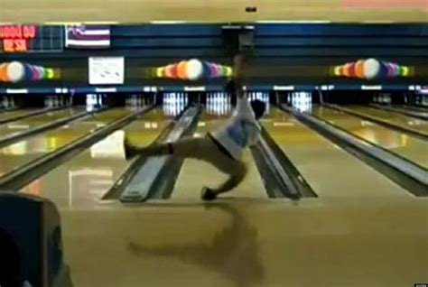 A Man Is Bowling Down A Bowling Alley