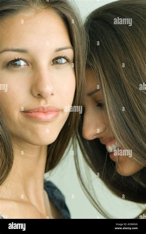Two Twin Teenage Sisters Smiling One Looking At Camera Stock Photo Alamy