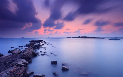 Sea Night Orange Sunset Sky Clouds Beach Stones Water Blue Surface Of Calm Boat Away Hd Wallpaper