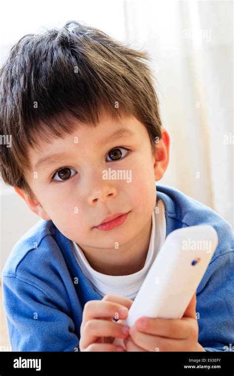 Caucasian Child Boy 5 6 Year Old Indoors Holding A Telephone In Hand