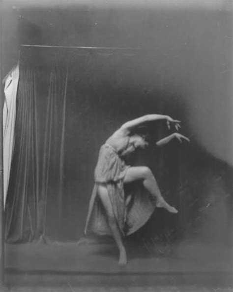 An Old Black And White Photo Of A Woman Dancing