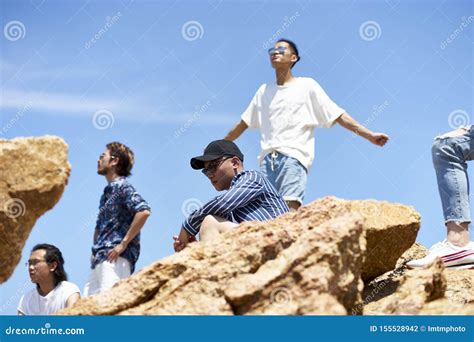 Young Asian Adult Men Standing On Top Of Rocks Stock Photo Image Of