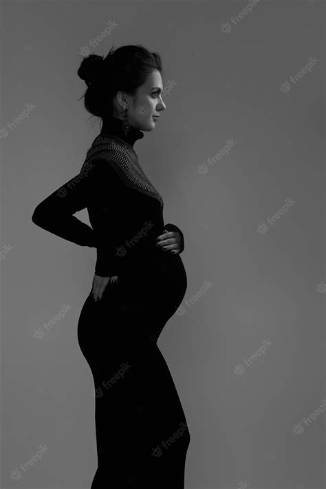 premium photo beautiful pregnant woman in dress holding her belly