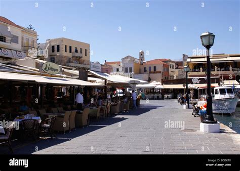 Traditional Greek Tavernas Line The Quayside Of Chania Harbour On The