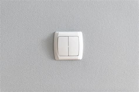 Premium Photo Simple Light Switch On Grey Wall