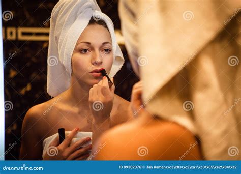 Portrait Of Woman In Panties And Lipstick In The Bathroom Looking In