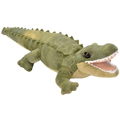 A Stuffed Alligator Is Laying Down With Its Mouth Open