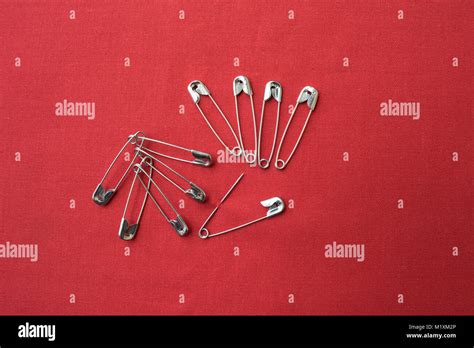 Many Safety Pins Against Red Background Stock Photo Alamy