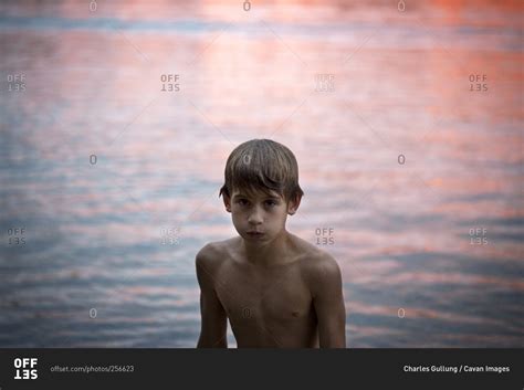 Young Boy By Water Puffing Out Cheeks Stock Photo Offset