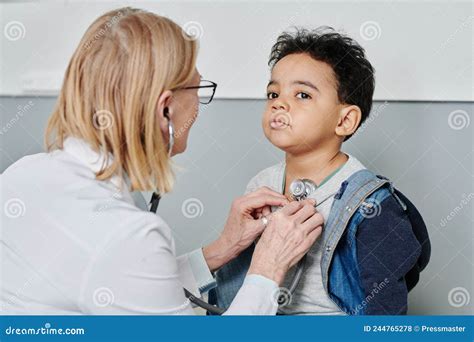 Cute Little Boy Having Medical Treatment During Visit Pediatrician In