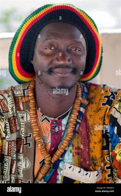 Senegalese Man In Reggae Style Jamaican Rasta Cap And Baye Fall Prayer