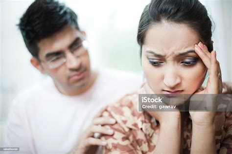 Woman Holding Head With Depression And Headache Man Consoling Stock