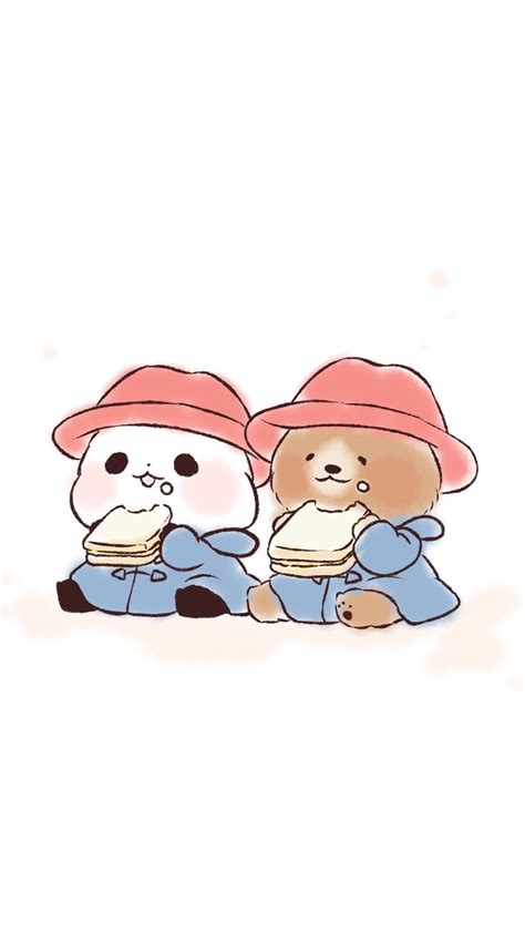 Two Small Teddy Bears Sitting Next To Each Other Wearing Hats And