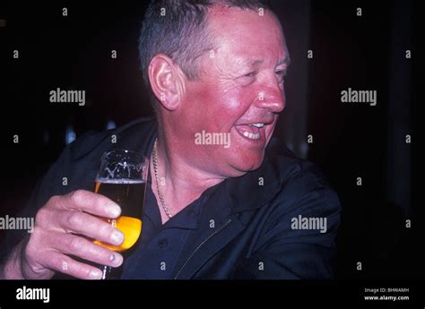 Man With Flushed Red Face From Alcohol Drinking Lager Stock Photo