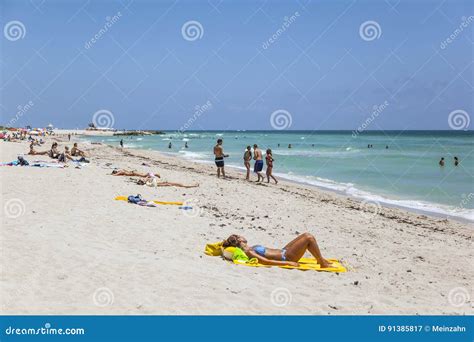 Tourists Sunbath Swim And Play On South Beach In Miami Beach F