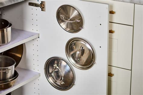 If you don't cook often, i'd recommend storing your pots and pans in a pantry or closed cabinet, so they don't collect grease and dust. Pot Lid Command Hook Hack - Cabinet Trick | Kitchn
