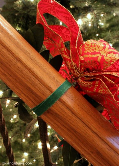 How To Hang Garland On Staircase Banisters - Oh My Creative