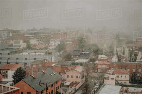 Urban Neighborhood View In The Winter With Fog And Snow Stock Photo