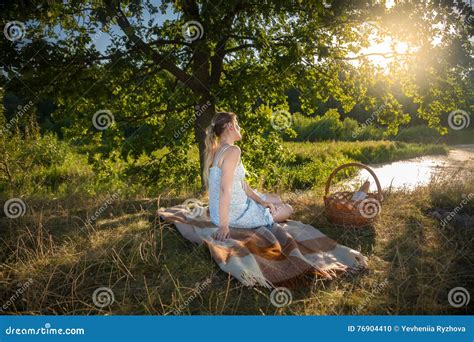 Beautiful Woman Sitting Under Big Tree At Field And Looking At S Stock