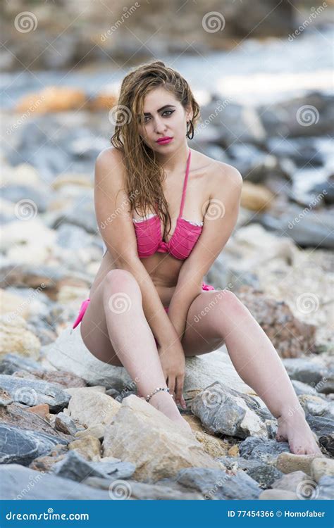 Woman Wear Pink Bikini Sitting On Sea Rocks Stock Photo Image Of