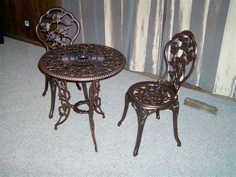 Feel like you're dining on a parisian sidewalk at a café without leaving your home. Beautiful Rose Cast Iron Bistro Set