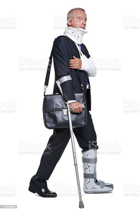 Injred Businessman Walking With Crutch Isolated On White Stock Photo