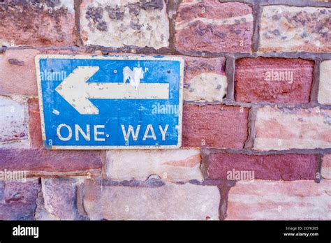 Brick Wall With Blue And White One Way Sign Stock Photo Alamy