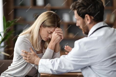 Premium Photo Therapist Man Comforting Upset Female Patient During