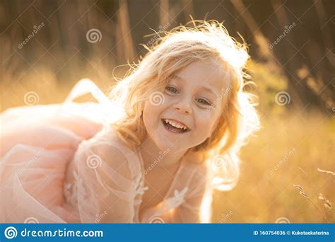 Portrait Of A Beautiful Little Princess Girl In A Pink Dress Posing In