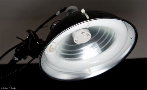 A beauty dish provides a light pattern that is kinda between what you get from a bare flash and a softbox. DIY Makeshift Continuous Light Beauty Dish - Brian C. Parks Photo+Design
