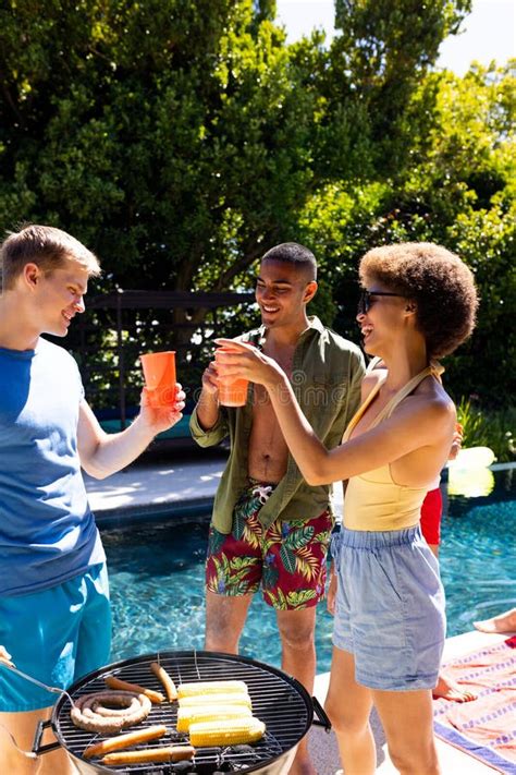 Happy Diverse Group Of Friends Having Pool Party Barbecuing Together In Garden Stock Image