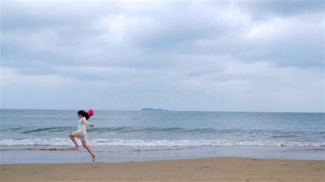 girl runs along the seashore in slow motion stock footage video of dress people 89897448