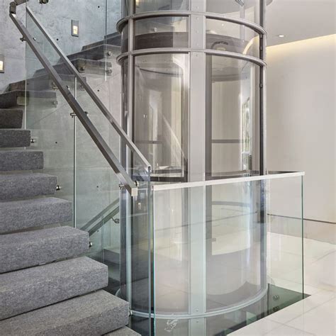A Spiral Staircase With Glass Railing And Handrail