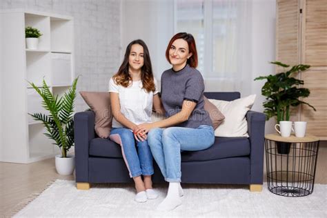 mother and daughter sitting in living room stock image image of