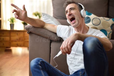 Man Sitting On The Floor Listening To Music Singing Stock Image Image