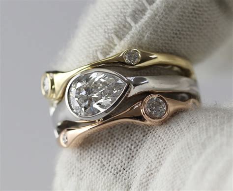 This setting holds the diamond or gemstone with a strip of metal that is wrapped around the stone. Horizontal Bezel Set Pear Shape Diamond Ring, 14K Gold ...