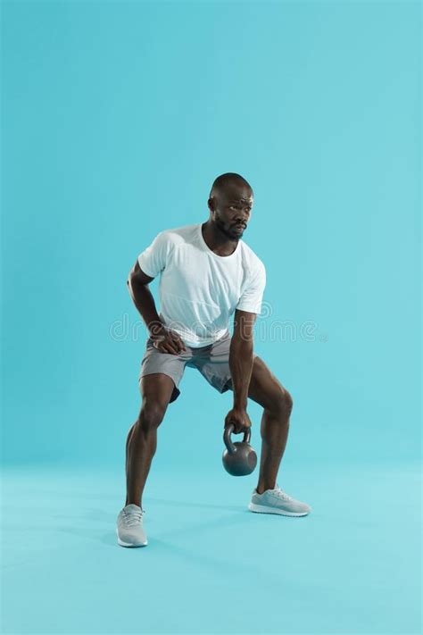 Kettlebell Workout Man At Gym Doing Exercise With Heavy Sport
