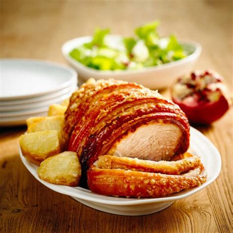 Place the pork loin on top of a rack inside of a roasting pan. Crackling pork leg roast with roasted potatoes and festive ...