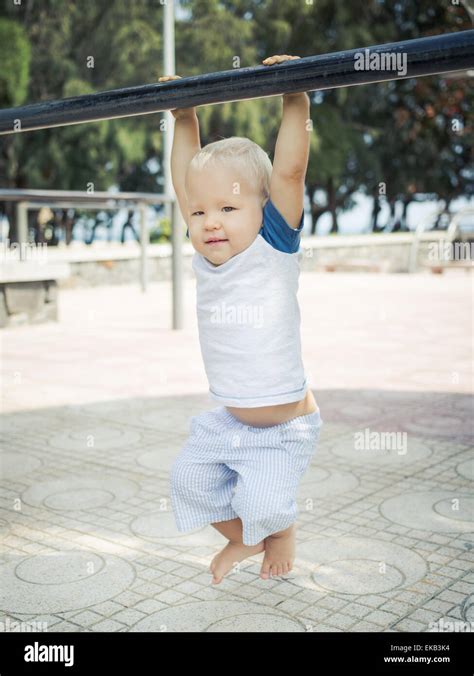 Baby Hanging On A Pull Up Bar Stock Photo Alamy